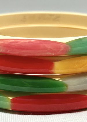 Shultz cream narrow bakelite bangles with rainbow colors of oval dots