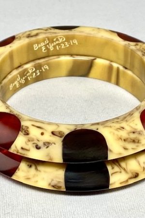 AB159 pair of Elfrink dotted saucer bakelite bangles