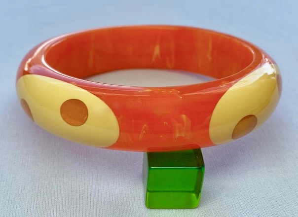 SZ10 Shultz marbled orange bakelite bangle with cream oval dots